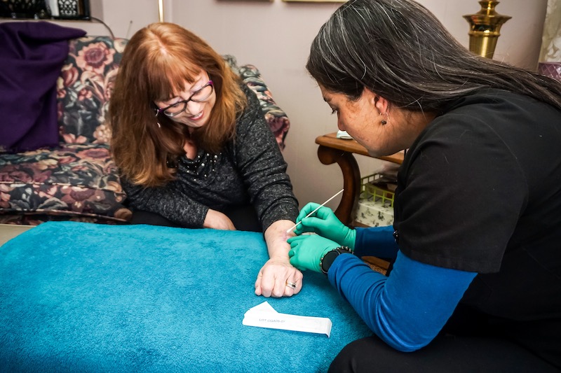 nurse with patient at home
